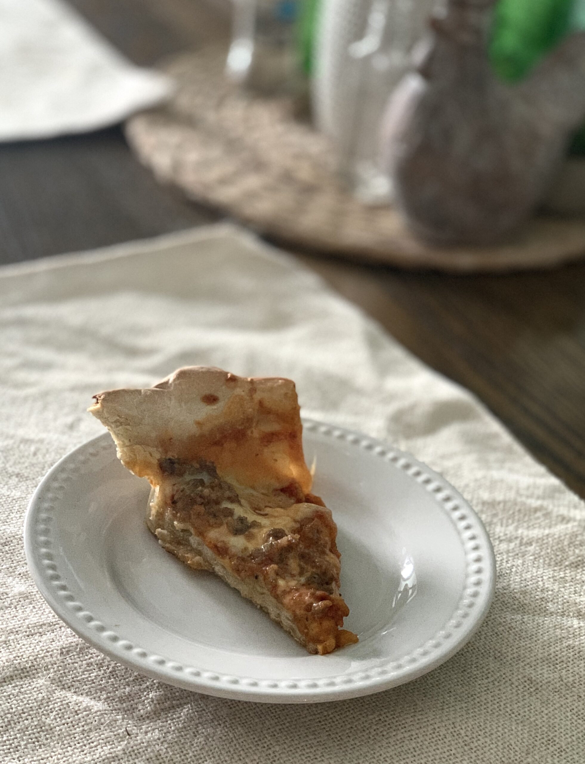 a slice of pizza on a white dish