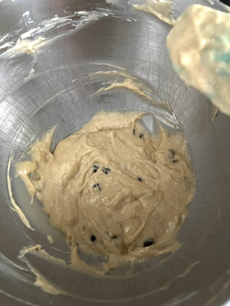 silver bowl of batter sprinkled with chocolate chips