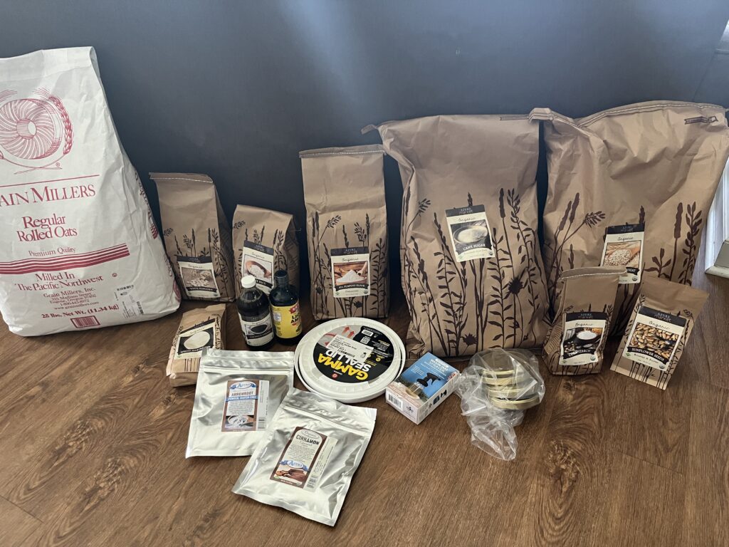 food products from Azure Standard lined up against the back of a gray couch