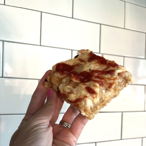 hand holding single square barbecue chicken pizza slice