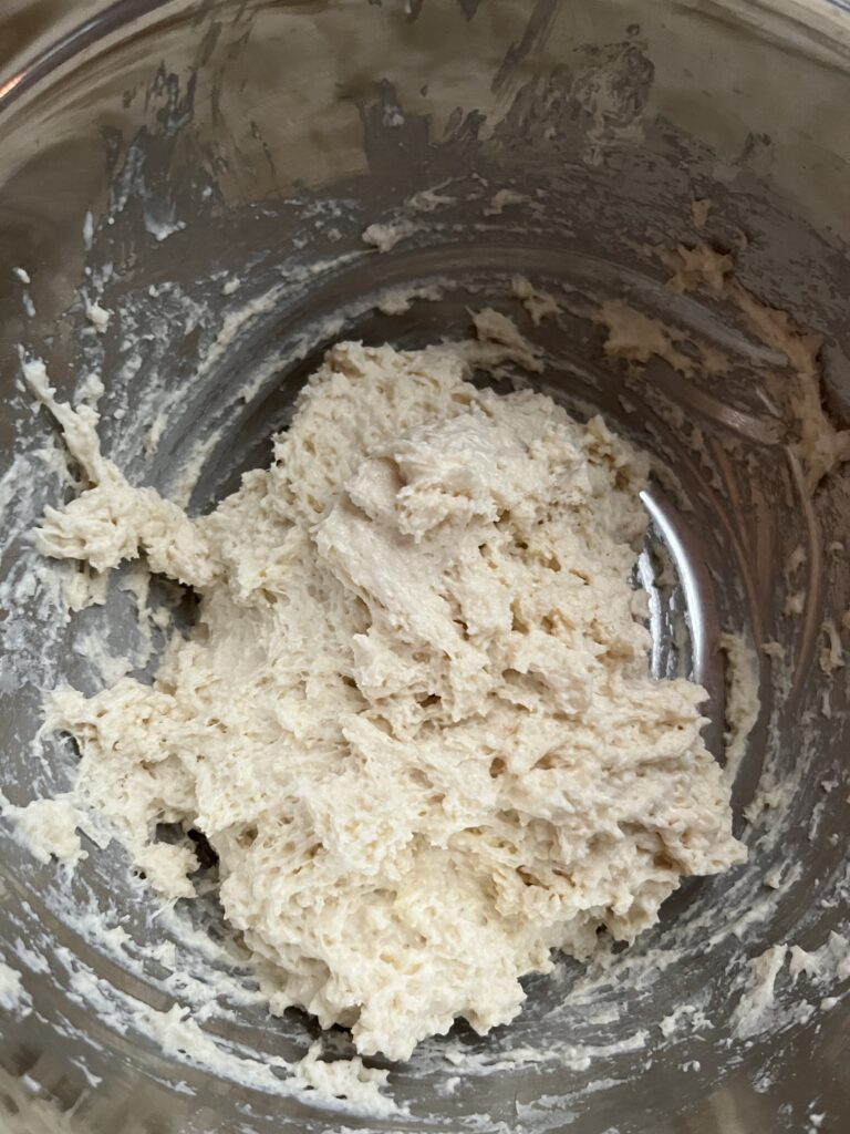 a stainless steel bowl of drop biscuit dough