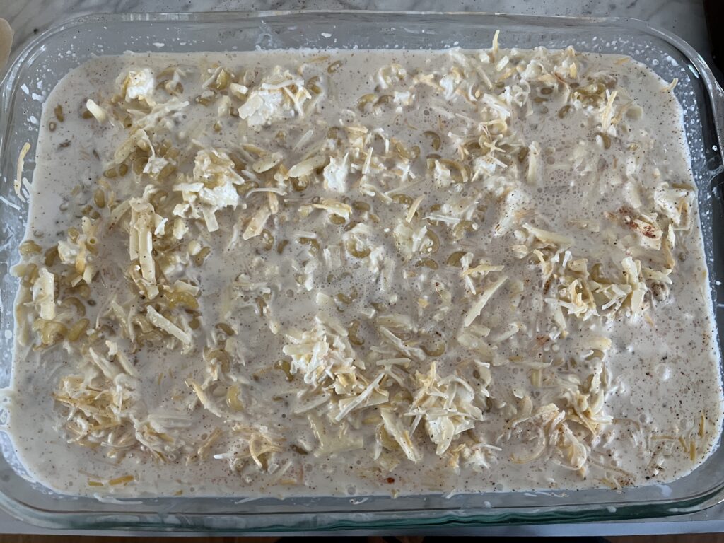 mix of uncooked Mac and cheese with milk, butter, and cheeses