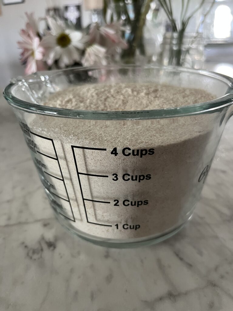 measuring cup of 4 cups of freshly milled wheat berries