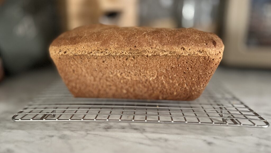 freshly milled honey wheat bread on a cooling rack