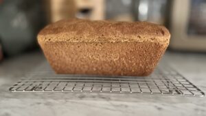freshly milled honey wheat bread on a cooling rack